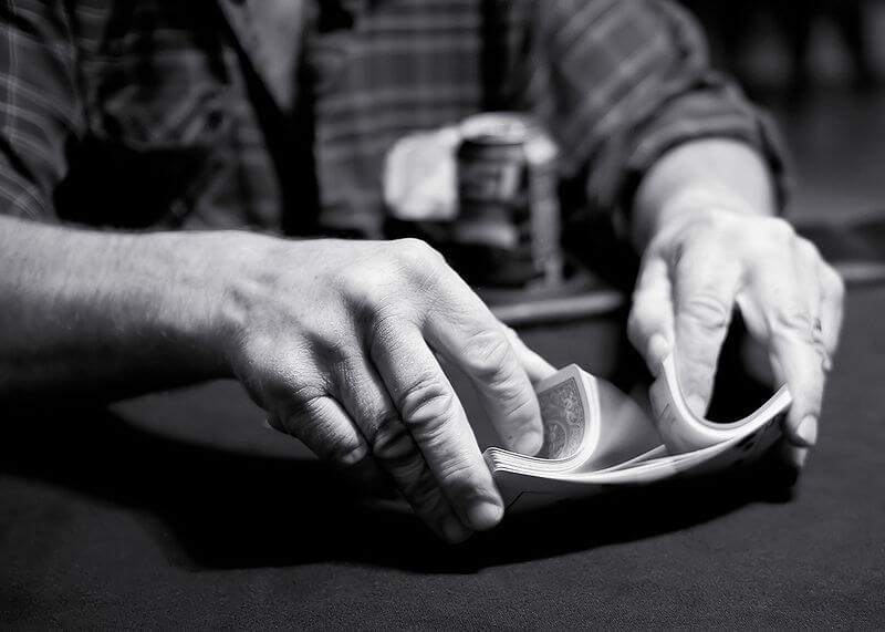 A riffle shuffle being performed during a game of poker at a bar near Madison, Wisconsin. Credit https://en.wikipedia.org/wiki/File:Riffle_shuffle.jpg