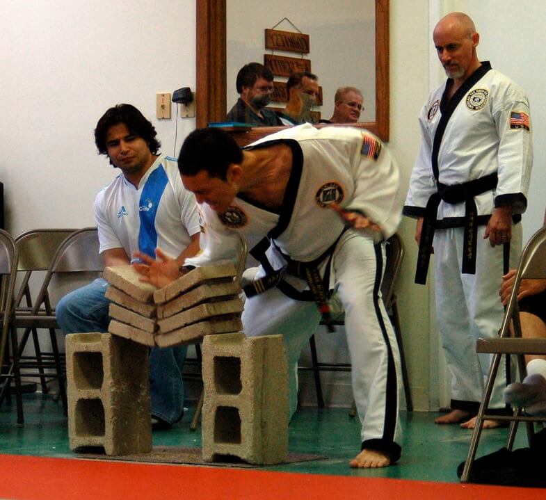 Photo of sabumnim Duke Lee courtesy of J. K. Lee Black Belt Academy. Credit https://en.wikipedia.org/wiki/File:Breaking_concrete.jpg